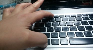 Typing punctuation marks on a laptop keyboard